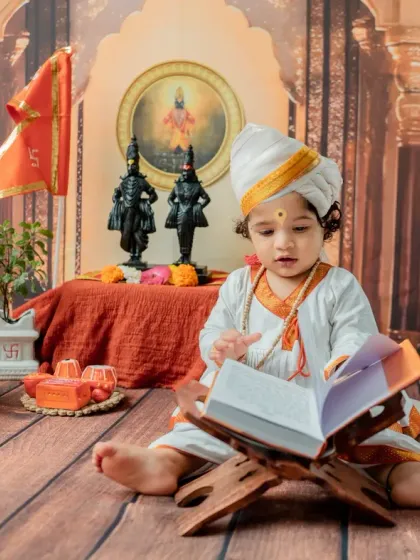 A focused shot of the baby turning the pages of the book, capturing his curiosity.