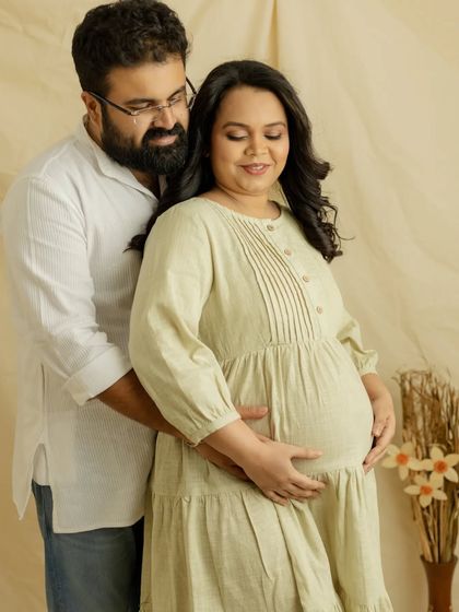 A lovely couple's portrait in soft, neutral tones. The gentle way he holds you from behind shows his love and support on this journey.