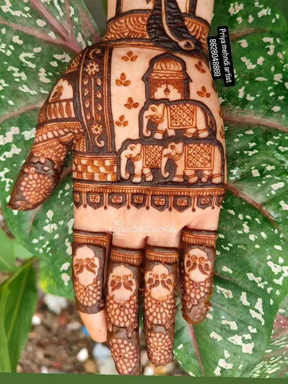 A close-up of a hand design featuring a family of elephants under a royal canopy. The fingers are detailed with small peacock heads, showing how I love to fill every space with meaningful and beautiful art.