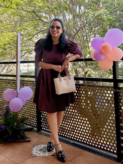 Dressed for a private party with a fun balloon backdrop. This outfit is a great example of a chic and comfortable look for hosting an intimate gathering.