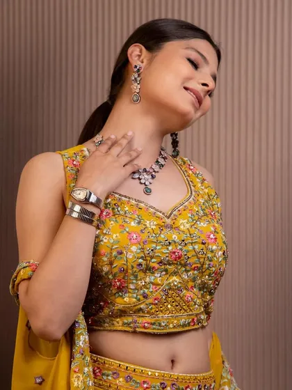 A close-up showcasing the detailed embroidery and flattering fit of our yellow festive sharara set. Feel confident and beautiful at your next event.