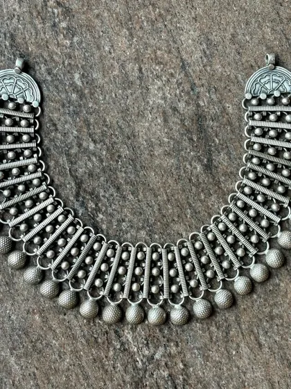 Another view of the multi-segment oxidised silver necklace, showing its flexibility and intricate construction.