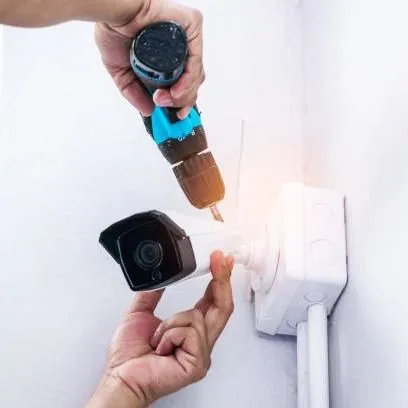 Our certified technician is shown carefully mounting a security camera. We handle every aspect of the installation, from drilling and wiring to system configuration, ensuring a secure and reliable setup.