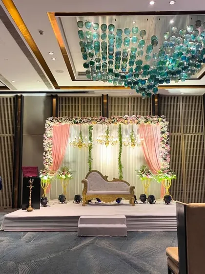 A wider view of the event space, showing how the stage design integrates with the venue's grand decor. I always consider the entire space when planning.