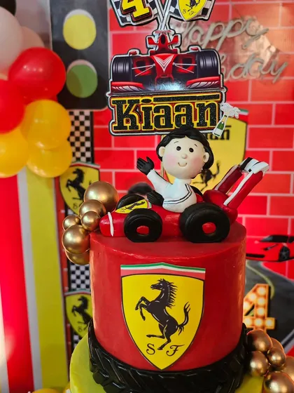 A close-up of the Ferrari cake topper, a hand-sculpted figurine of the birthday boy in his racing car.