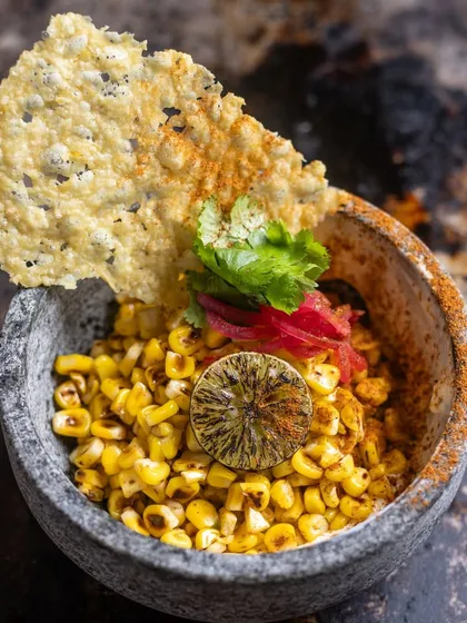 My Esquite is a delightful mix of charred corn kernels, confit garlic, aioli, and cilantro, a perfect appetizer.