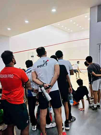 The team intently watching a match, learning from every point. This is part of our supportive training environment.