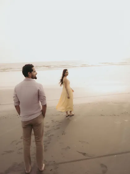 A candid moment of him watching her by the sea. These unposed shots often tell the most beautiful stories.