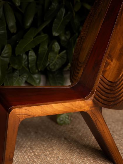 Various angles of the Vismayam chair, showcasing its intricate details, the contrast of different wood grains, and its powerful, sculptural presence. Each view offers a new perspective on this piece of collectible, art-inspired furniture.