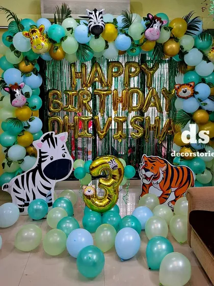 A centered view of the jungle safari decoration, highlighting the personalized 'Happy Birthday' name banner and the number '3' foil balloon.