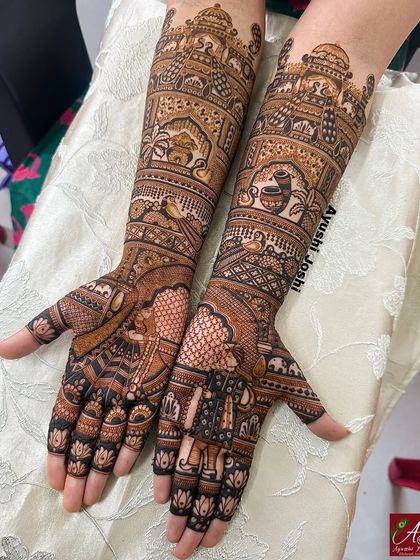 The full view of the bridal mehendi, showing how the armband designs complement the figures on the palms.