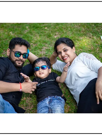 A fun and relaxed family photo with everyone lying on the grass. I love creating casual and playful portraits that reflect your family's personality.