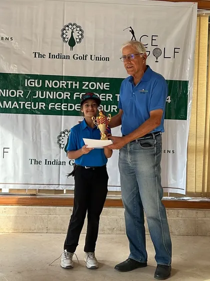 Aaliyah Kalra receives her winner's trophy for Category D at the IGU Sub-Junior & Junior Feeder Tour, where she also scored a hole-in-one.
