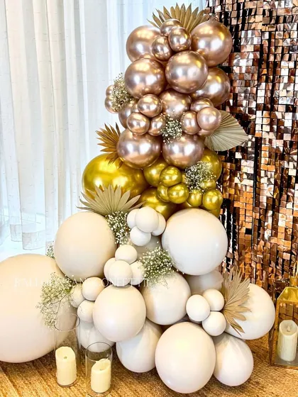 A detailed shot of the balloon work for this glam birthday. I used a mix of white, gold, and rose gold chrome balloons, accented with baby's breath and dried palms for texture.