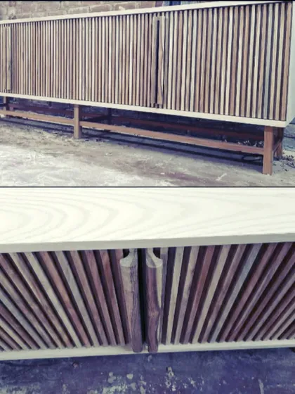 A look at a media console during its final stages in our workshop. The design features vertical wood slats that create a beautiful textural effect and cleverly conceal the handles.