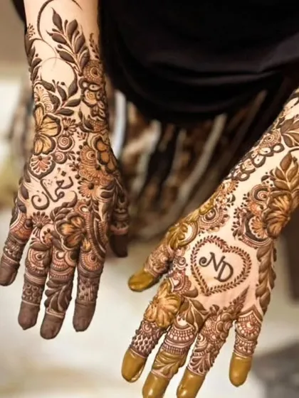 I love creating modern Arabic and Dubai style henna. This design combines a bold floral vine with the couple's initials, ND, inside a heart. It's elegant, personal, and leaves beautiful negative space on the skin.