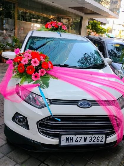 A bright and cheerful look for this Ford EcoSport. We used vibrant pink gerbera daisies and matching pink fabric to create a fun and eye-catching design for the wedding day.