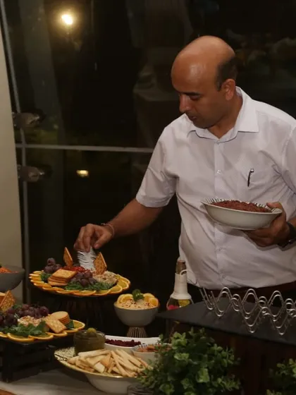 A throwback to me setting up a grazing platter at an event. It's a hands-on process to ensure everything looks as good as it tastes.