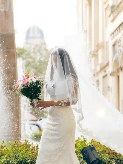 A stunning shot of the Catholic bride with her long, flowing veil. The makeup is kept elegant and understated to complement the classic bridal look.