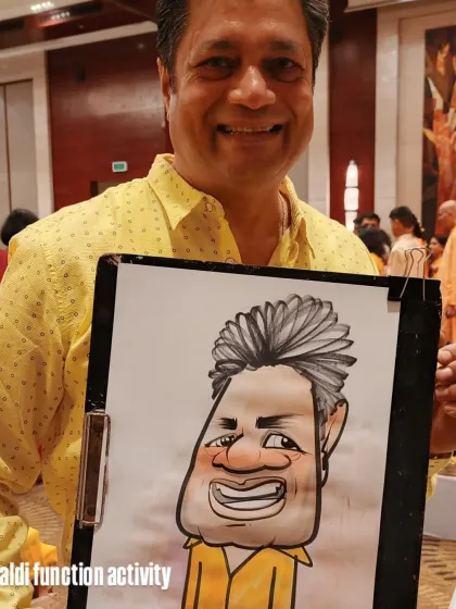 The yellow of his shirt and the yellow background in the caricature tie everything together nicely. A great memory from a Haldi function.
