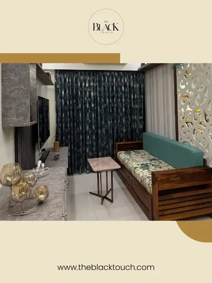 A cozy living space featuring a wooden sofa-cum-bed and a decorative partition. This is another example of our expertise in designing for compact homes.