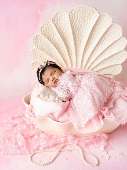 Your baby is a precious pearl, and this setup brings that idea to life. Nestled in a beautiful seashell prop, this little one is the definition of a hidden treasure.