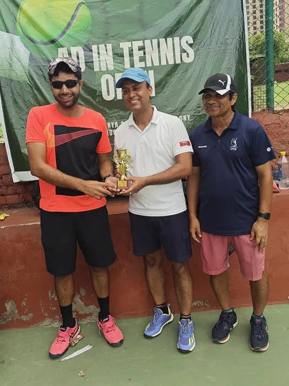 An official presenting the winner's trophy in the Men's 35+ category. Our tournaments cater to dedicated players of all ages.
