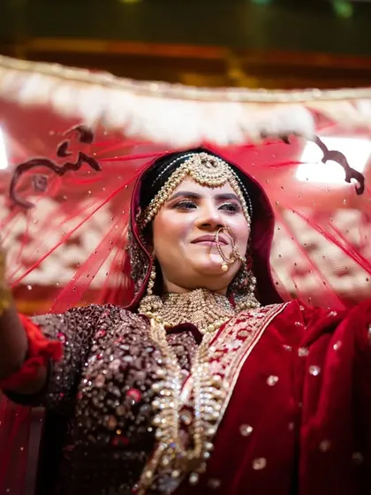 A stunning portrait of a Muslim bride lifting her veil, her eyes full of dreams and happiness.