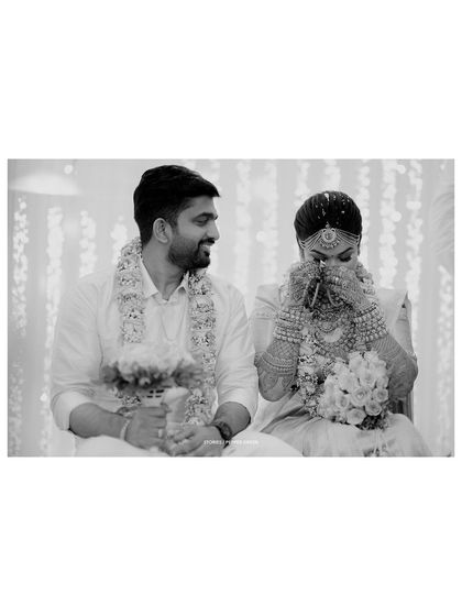 A black and white photo of Chaithanya and Abhiram during an emotional moment in their ceremony. The lack of color draws focus to their expressions and the significance of the ritual.