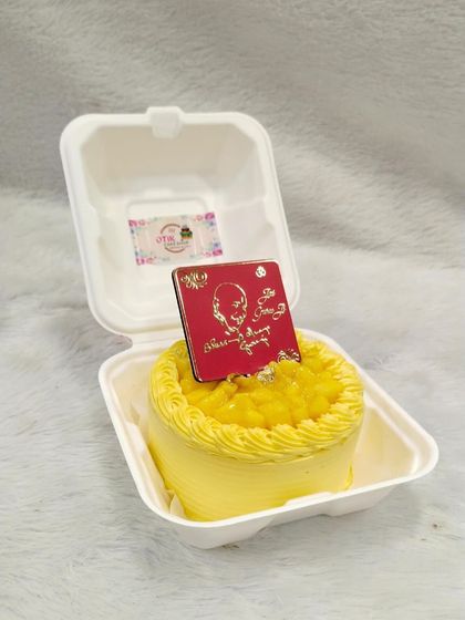 A bright yellow mango-flavored bento cake, specially designed for Guruji's birthday celebrations.