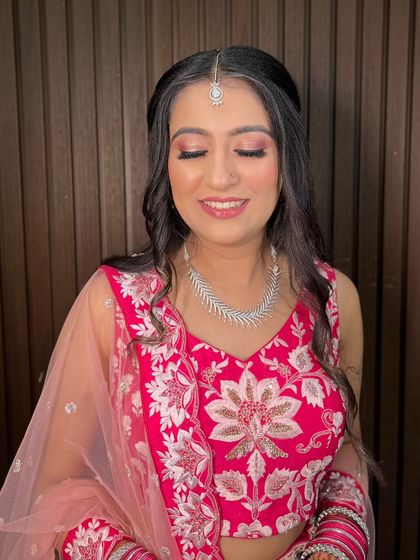 A moment of quiet joy. The soft, shimmering eyeshadow catches the light beautifully, adding a touch of magic to her engagement day makeup.