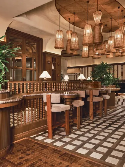 Another view of the high-top seating, showing the dialogue between the graphic floor pattern and the organic texture of the lighting.