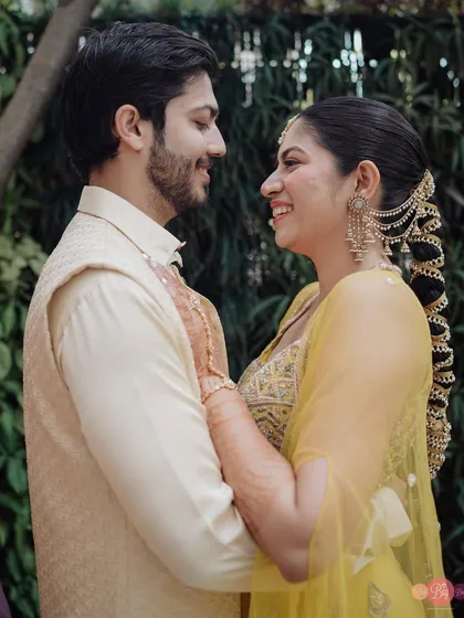 The way they look at each other says everything. A beautiful candid moment from their pre-wedding shoot in traditional yellow outfits.