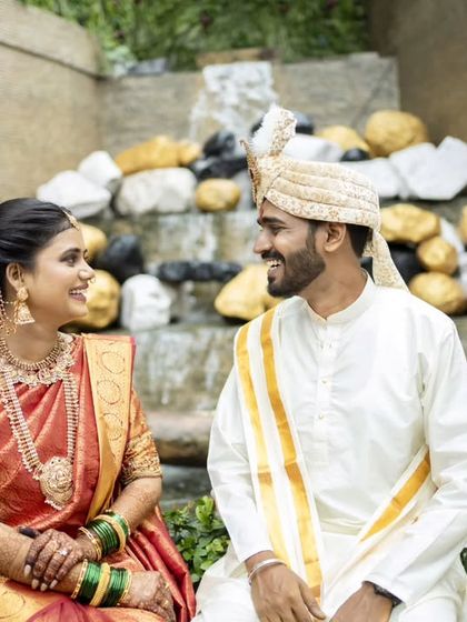 A sweet, seated portrait by a waterfall, creating a serene and romantic atmosphere.