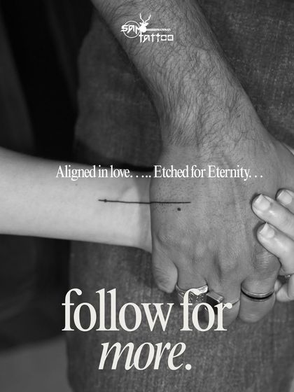 A minimalist couple tattoo. A single line connects their wrists when they hold hands, symbolizing their eternal alignment in love.