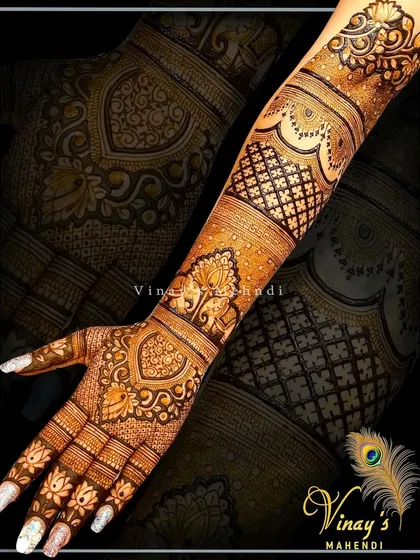 A beautiful back-of-hand design with repeating paisley and floral bands extending up the arm.