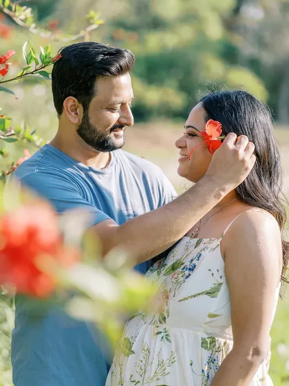 A sweet, playful moment where he gently places a flower in her hair. It’s these small, unscripted gestures of love that often make the most beautiful photographs.