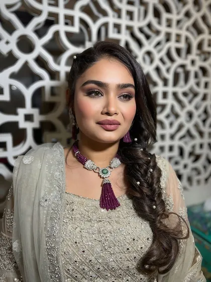 A side profile showing the beautiful braided hairstyle and the soft makeup.