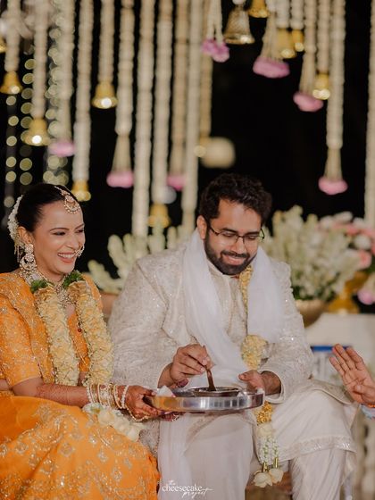 The couple sharing a lighthearted moment during their wedding rituals.