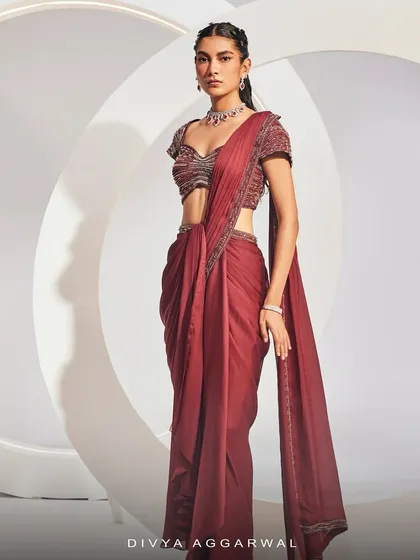 A side profile of the IRIE Saree Set, highlighting its sleek silhouette and the intricate beadwork along the border of the drape.