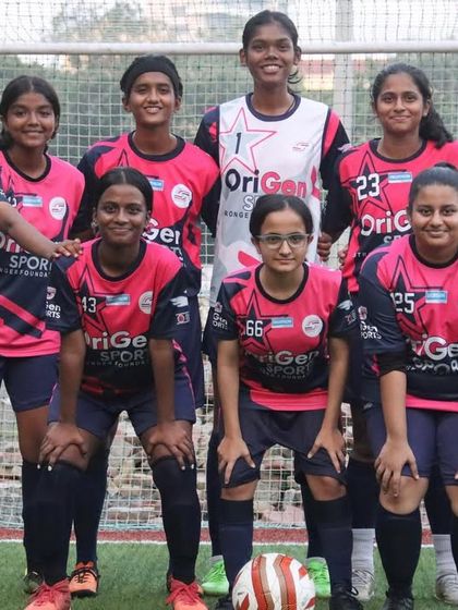 Our full girls' team posing for a photo before their match, united and ready to play.