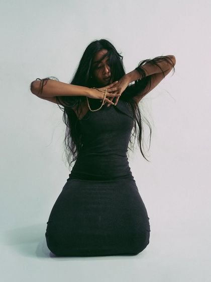 An artistic pose that plays with shapes and lines, great for showing a model's creative potential.