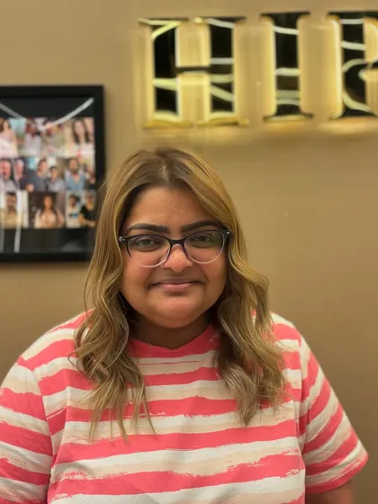 A frontal view of a client's hair color transformation. The new shade brightens her features and gives her a confident glow.