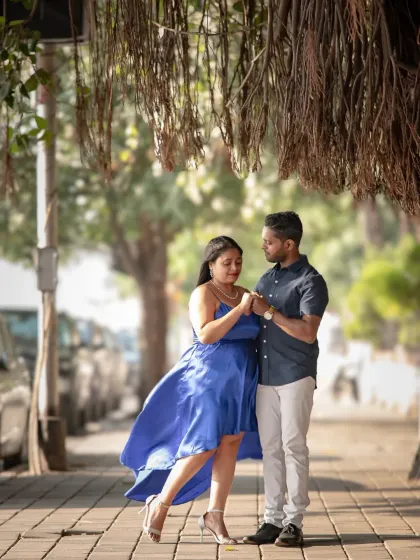 A romantic moment on a city sidewalk, with the wind catching her dress perfectly. I love using the urban environment to create beautiful, candid-style pre-wedding photos.