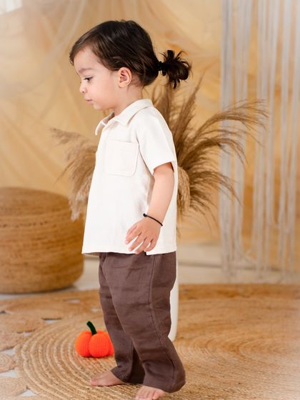 A quiet, candid profile shot. The earthy tones and simple props create a calm and natural feel.