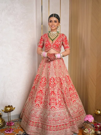Every detail matters in creating the perfect bridal look. This full-length shot showcases how the makeup, hair, and stunning red lehenga come together to create a cohesive and breathtaking vision of a modern Indian bride.