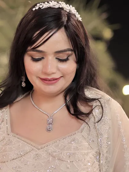 A close-up with eyes closed, showcasing the subtle and clean eye makeup.