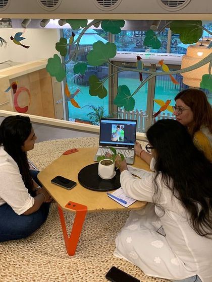 In a cozy nook overlooking the play area, our educators meet with parents. We believe in creating a comfortable and transparent environment for these important conversations about a child's growth and development.