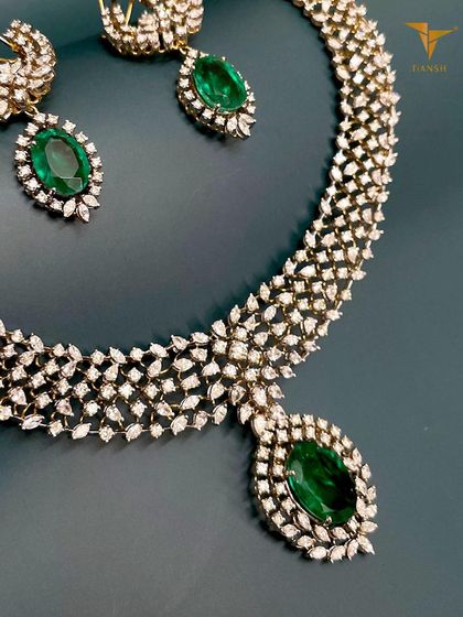 For those who embrace elegance at every turn, this prong set diamond and emerald necklace radiates sophistication and charm. It is the perfect accessory for moments that call for understated luxury.