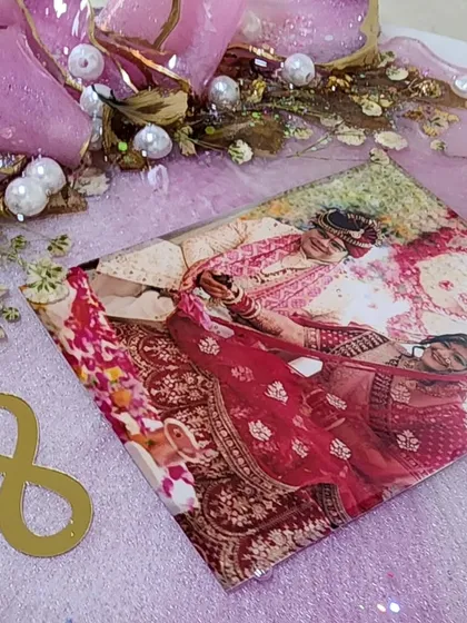 A close up of a wedding frame in the making. The pink glitter and pearl accents add a touch of sparkle.